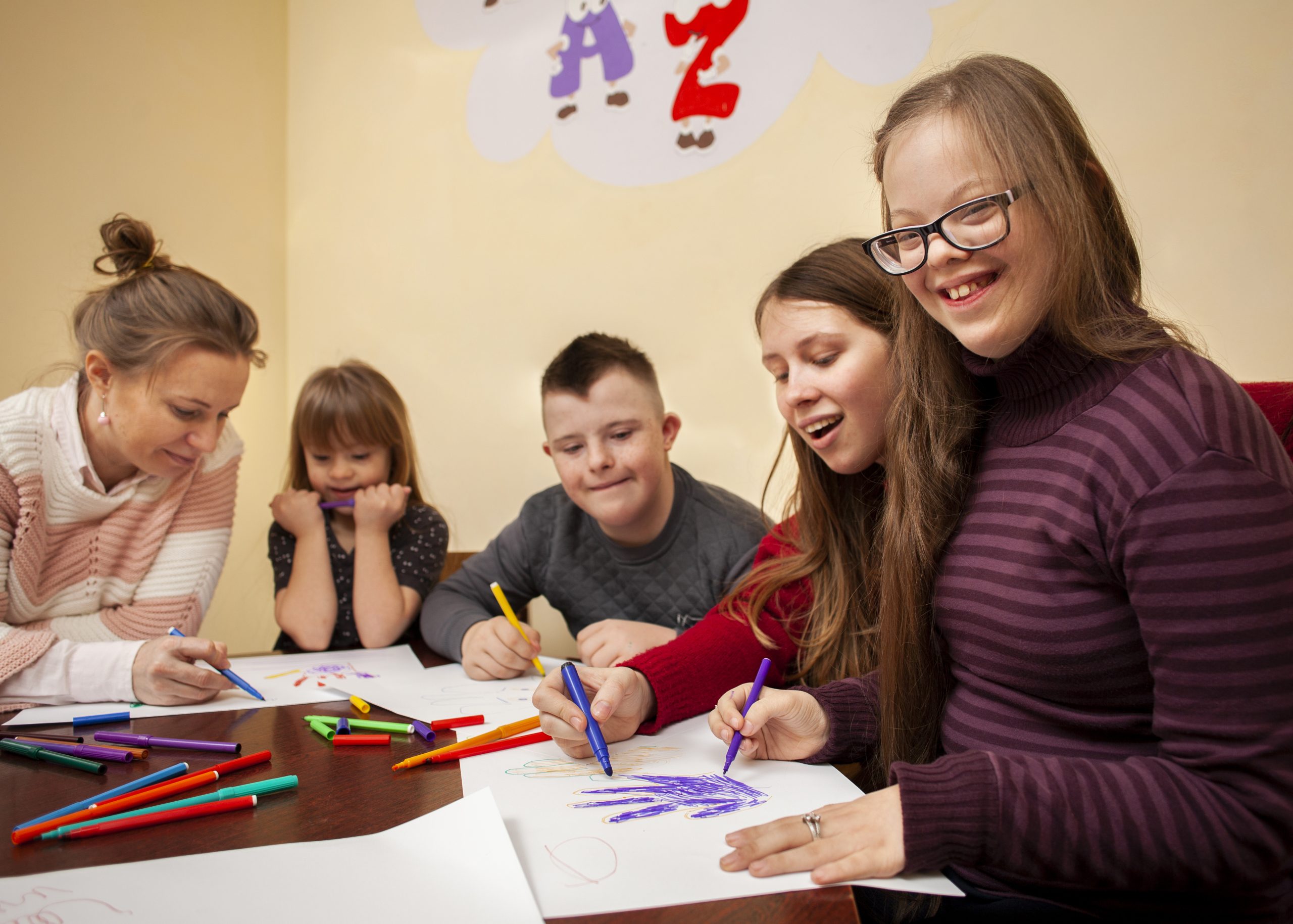 happy-girl-with-down-syndrome-posing-while-drawing