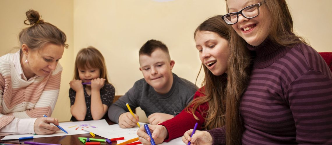 happy-girl-with-down-syndrome-posing-while-drawing